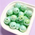 Detailed view of 16mm mint green iridescent UV electroplated acrylic beads in a white bowl - 1 Piece / Light Green