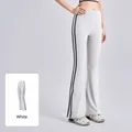 Athletic white high-waist yoga flare pants featuring black side stripes and elastic fit - S / Bottoms / White