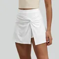 High waist white athletic tennis skort featuring a stylish front knot and built-in liner - S / Bottoms / White