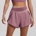Stylish pink color-blocked high-waisted yoga shorts with a crossed waistband design - Creamy Purple