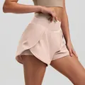 High waist color-block yoga shorts in peach pink with layered design for fitness. - Lotus Pink