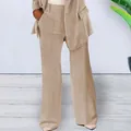 Detailed view of elegant khaki women's two-piece business suit set with blazer and trousers - S / Bottoms / Apricot