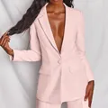 Detail view of a stylish light pink women's blazer suit with a single button closure - S / Top And Bottom / Pink