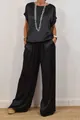 Full view of women's elegant black satin two-piece set with wide-leg trousers for 2025 - XS / Top And Bottom (03076) / Black