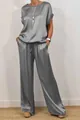 Detailed view of women's elegant grey satin loose top and wide-leg trousers casual set - Gray