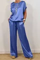 Detail of blue satin lounge set showing loose top and wide-leg pants with drawstrings - Blue