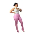 Model wearing high-waisted shiny pink PU leather pants with a stylish split hem - S / Bottoms / Pink