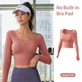 Honey pomelo pink long sleeve yoga crop top with built-in chest pads and thumb holes - Peach Pink