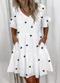 Detail view showing the tiered design and heart print of this stylish white summer dress - Heart