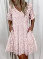 Detail view of a pink leopard print V-neck summer dress with tiered ruffled hem and pockets - S / Top And Bottom / Pink