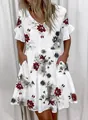 Detailed view of white floral summer dress with V-neckline and functional pockets - S / Top And Bottom / Flower