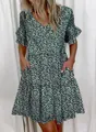Close-up detail of green floral V-neck summer dress featuring ruffles and pockets. - S / Top And Bottom / Green