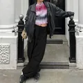Street style detail of black wide-leg cargo pants with adjustable drawstring waist - S / Black