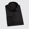 Classic men's long-sleeve business dress shirt in solid black, folded neatly. - M / Tops / Black