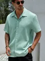 Detail view of men's mint green short sleeve shirt with unique crinkle texture fabric - Green