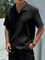 Macro view of black men's short sleeve casual shirt showing textured waffle fabric - S / Tops / Black