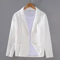 Close-up view of a white cotton linen blazer for men featuring front pockets and buttons - M / Tops / White