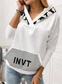 Close-up detail of white women's hoodie featuring a sequined INVT letter print pocket design - S / Tops / White