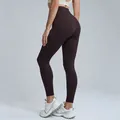 High-waisted dark brown quick-dry yoga leggings shown from a side-back studio view - S / Bottoms / Pants / Distilled Coffee