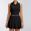 Detalle del conjunto deportivo de polo negro sin mangas con cremallera y falda plisada - S / Top Y Pantalón / Negro Premium