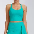 Detail shot of a turquoise yoga sports top featuring fixed pads and elastic fabric texture. - S / Tops / Maldives Green