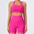 Vibrant hot pink women's yoga set featuring a sports bra and high-waisted athletic shorts - S / Top And Bottom / Bra + Shorts / Roselle Red