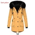 Close-up detail of a dark yellow women's winter parka with a large black faux fur collar - S / Tops / Gold Yellow