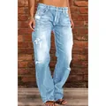 Detailed close-up showing light blue washed distressed denim jeans worn by a model - S / Bottoms / Light Blue