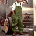Salopette cargo vintage da uomo verde oliva su uno sfondo di un vecchio camion - Taglia S / Top E Pantaloni / Verde militare