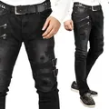 Detailed view of black men's biker skinny jeans with decorative zippers and buckles - S / Bottoms / Black