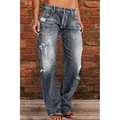 Detailed macro view of women's grey distressed washed jeans with ripped accents - S / Bottoms / Gray