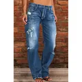 Detailed view of women's blue distressed denim jeans showing ripped wash effects. - S / Bottoms / Dark Blue