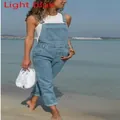Full length view of woman wearing light blue denim overalls over white top on beach - S / Top And Bottom / Light Blue
