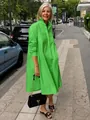 Model wearing a vibrant green cotton linen maxi shirt dress in a street setting - S / Tops / Green