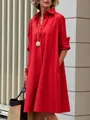 Bright red cotton linen loose midi shirt dress worn by a model in an urban setting - Red