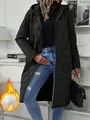 Detail of a long black hooded quilted women's coat featuring a wavy padded design - S / Tops / Black