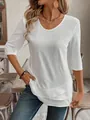 Detail view of a white casual top featuring a unique layered hem and textured fabric - S / Tops / White