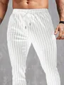 Detail van witte heren slim-fit broek met zwarte verticale strepen en trekkoord in taille - M / Bottoms / Wit