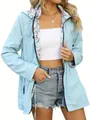 Detail view of women's light blue waterproof jacket showing elegant floral lining - Sky Blue