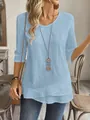 Detail view of a light blue textured blouse featuring a stylish layered hem design - Lake Blue