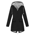 Close-up detail view of a black outdoor hooded raincoat with chic striped lining - S / Tops / Black