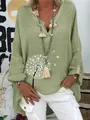 Detailed view of light green linen V-neck blouse with white dandelion print - S / Tops / Green