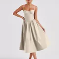 Detail shot of a French vintage beige corset dress featuring a pleated midi skirt. - S / Bottoms / Apricot