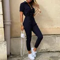 Detailed view of navy blue short sleeve utility jumpsuit with lapel and waist tie. - Navy Blue