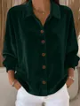 Close-up detail of emerald green velvet shirt featuring brown buttons and soft texture - Green
