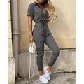 Full view detail of grey short-sleeved utility jumpsuit with waist tie and buttons - Gray