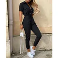 Full-body view of a stylish black short-sleeved cargo jumpsuit with lapel and tie-waist belt - S / Top And Bottom / Black