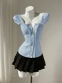 Detail view of a light blue puff sleeve shirt with waist-cinching design on a mannequin - S / Tops / Light Blue