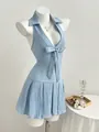 Close-up detail of light blue halter neck dress with bow and pleated skirt on mannequin - S / Tops / Light Blue