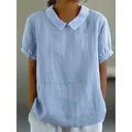Close-up of light blue cotton linen blouse with elegant Peter Pan collar design. - S / Tops / Light Blue